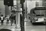 vintage image of boy holding lamppost with COTA bus in background